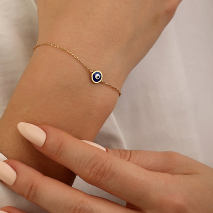 Dainty 18K gold evil eye protection bracelet with symbolic blue evil eye charm
