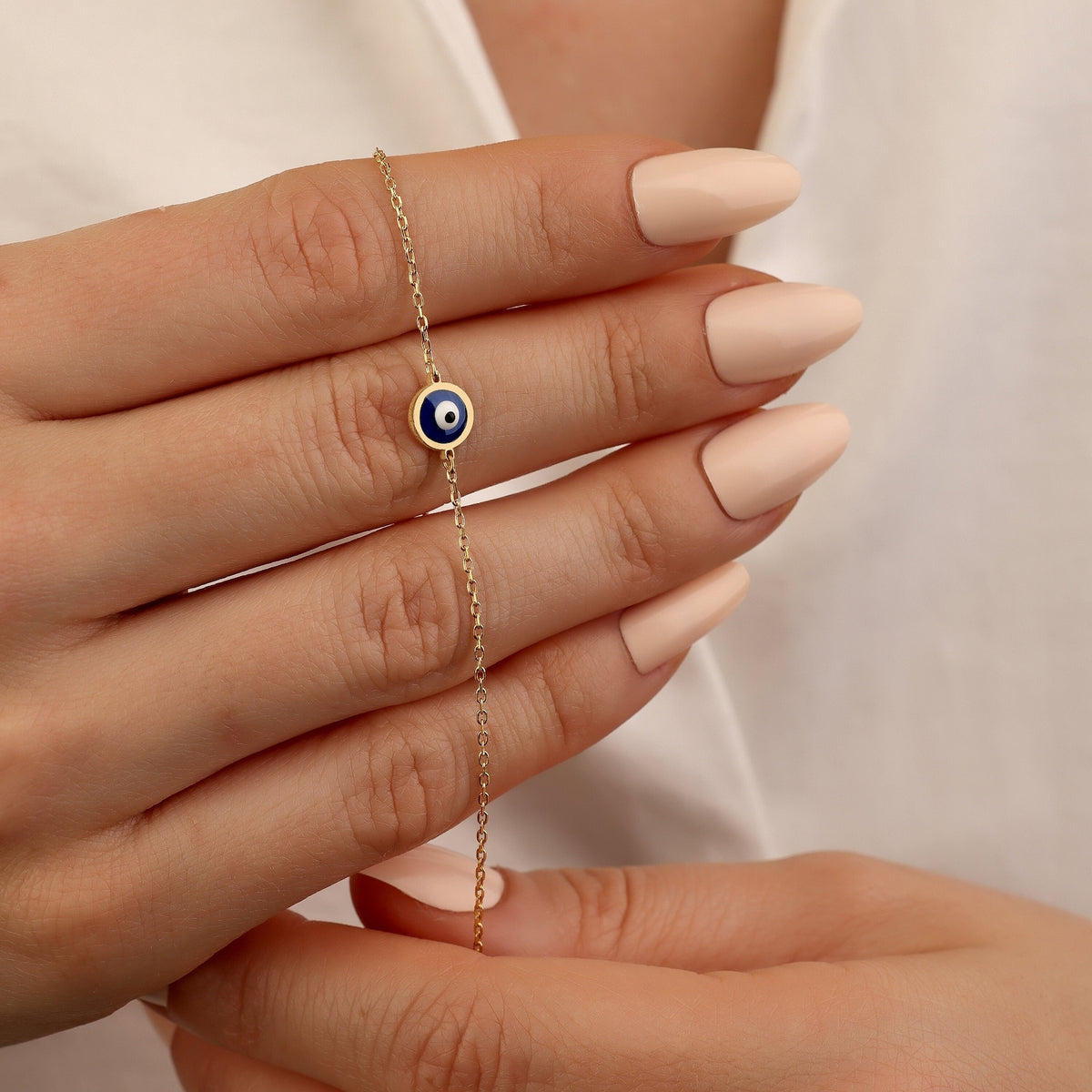 Dainty 18K gold evil eye protection bracelet with symbolic blue evil eye charm