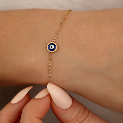 Dainty 18K gold evil eye protection bracelet with symbolic blue evil eye charm