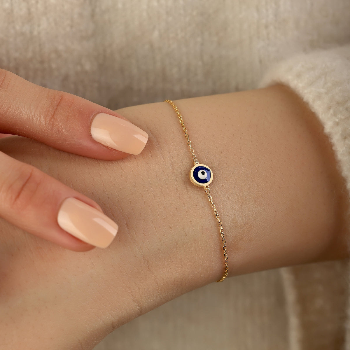 Dainty 18K gold evil eye protection bracelet with symbolic blue evil eye charm