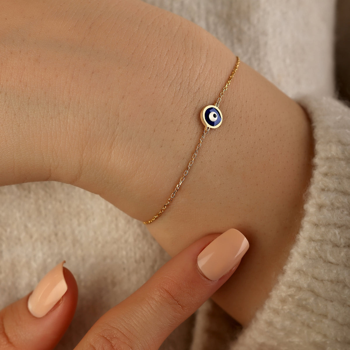 Dainty 18K gold evil eye protection bracelet with symbolic blue evil eye charm