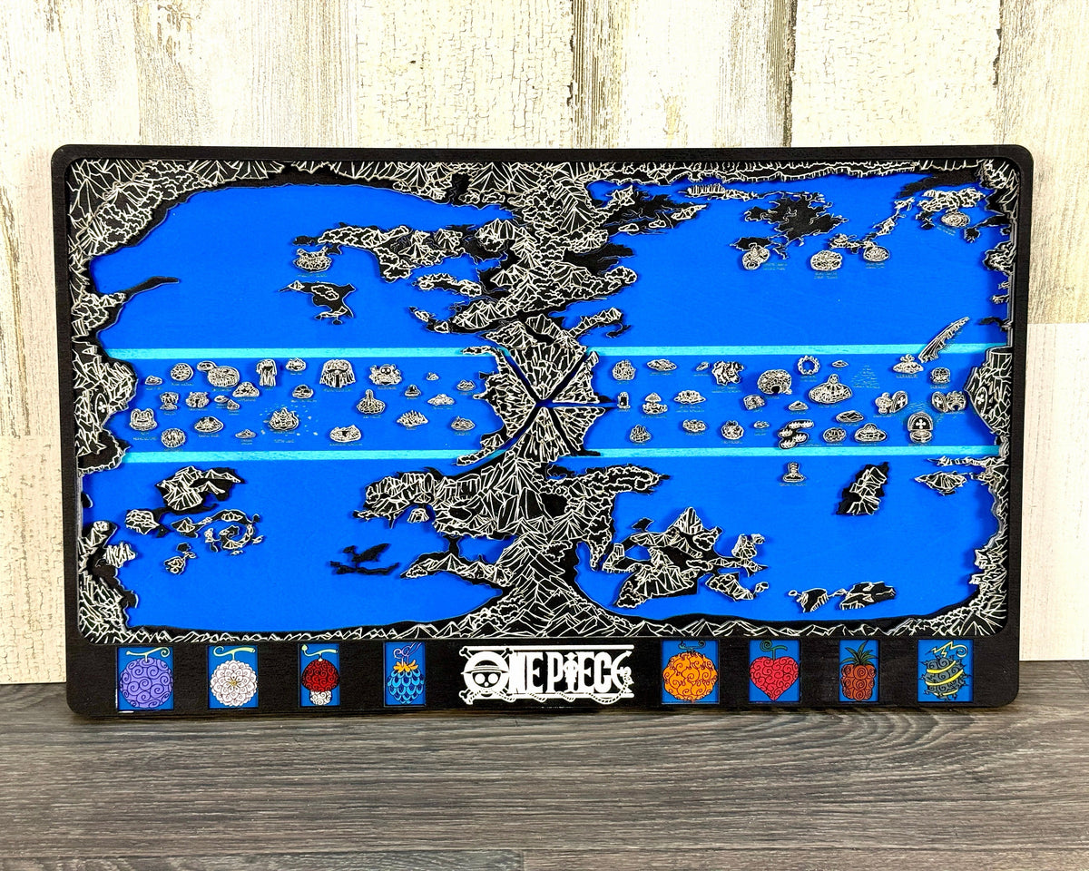 Black layered One Piece world map with white line detail, blue sea and eight fruit panels against a whitewashed wall.