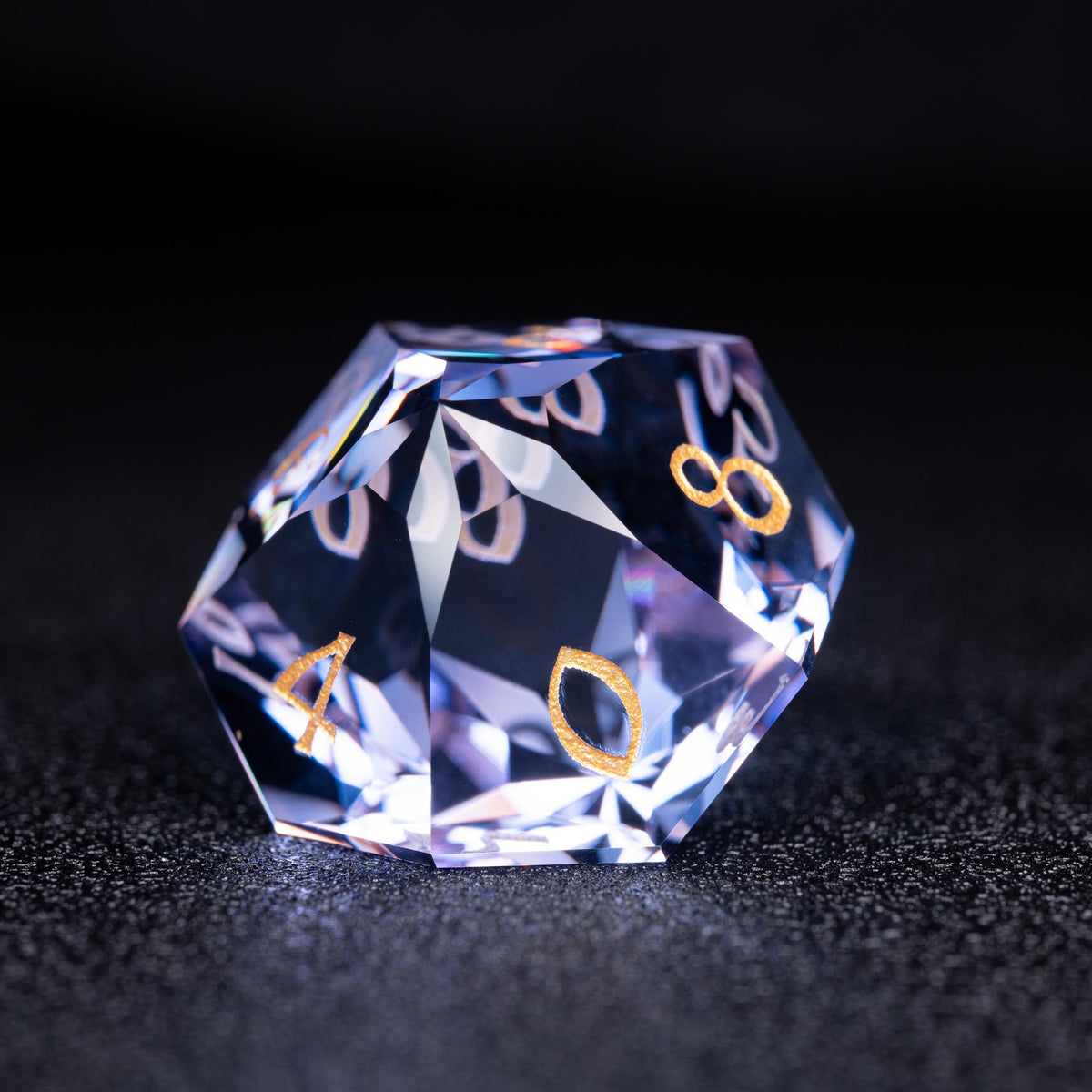 Faceted blue-violet clear d10 die with gold numbers 4, 0 and 8 on a dark sparkly surface