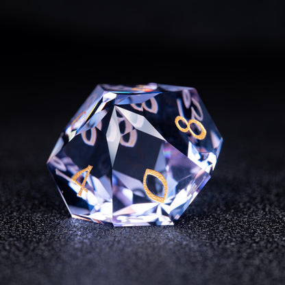Faceted blue-violet clear d10 die with gold numbers 4, 0 and 8 on a dark sparkly surface