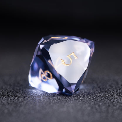 Faceted blue-violet clear d8 die with gold numbers 5 and 8 on a dark sparkly surface