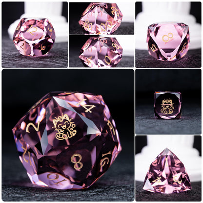 Collage of seven pink clear dice with gold numbers; d20 and d6 show a gold smiling cat-like creature, dark backdrop