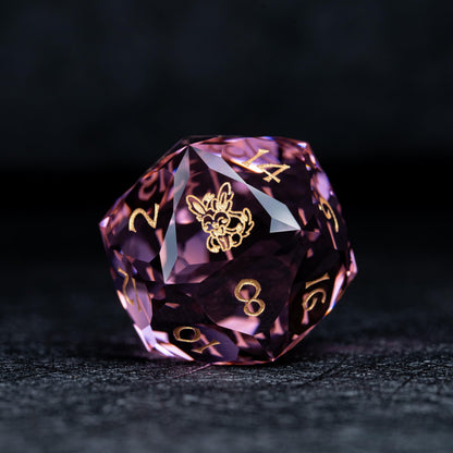 Faceted pink clear d20 die with gold numbers and a gold bunny-like creature symbol on a dark textured surface