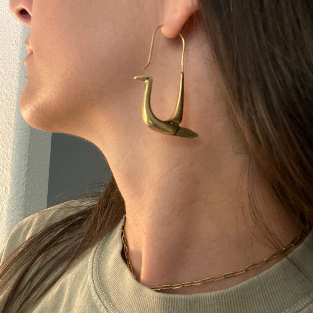 Handcrafted polished brass swan hoop earrings with sculptural bird design