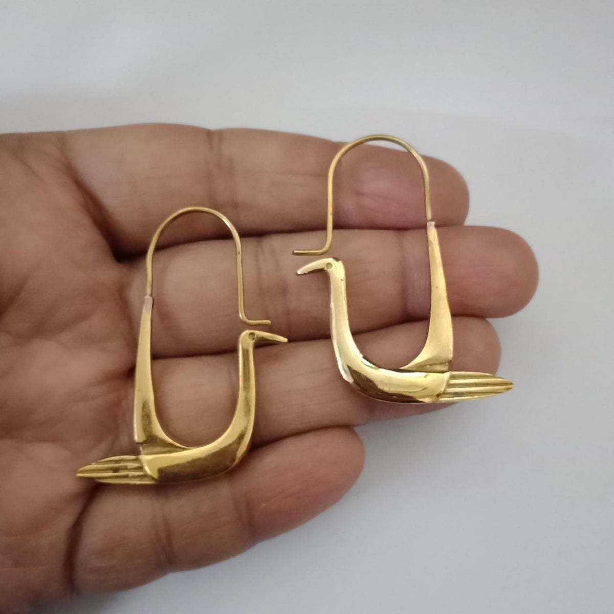Handcrafted polished brass swan hoop earrings with sculptural bird design