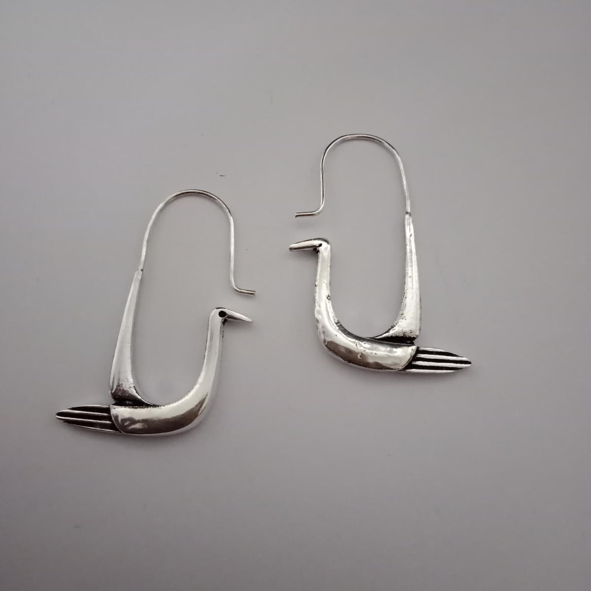 Handcrafted polished brass swan hoop earrings with sculptural bird design
