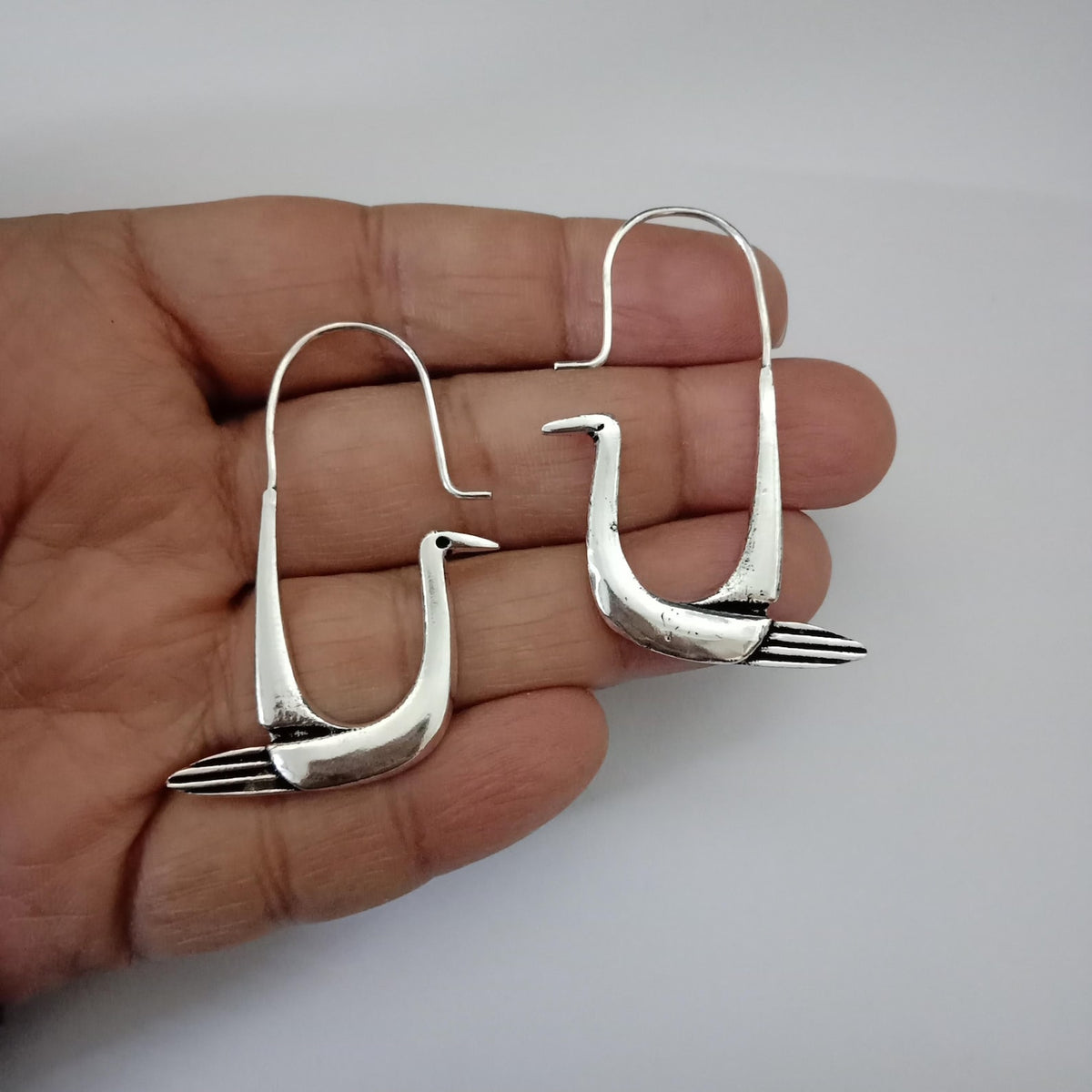 Handcrafted polished brass swan hoop earrings with sculptural bird design