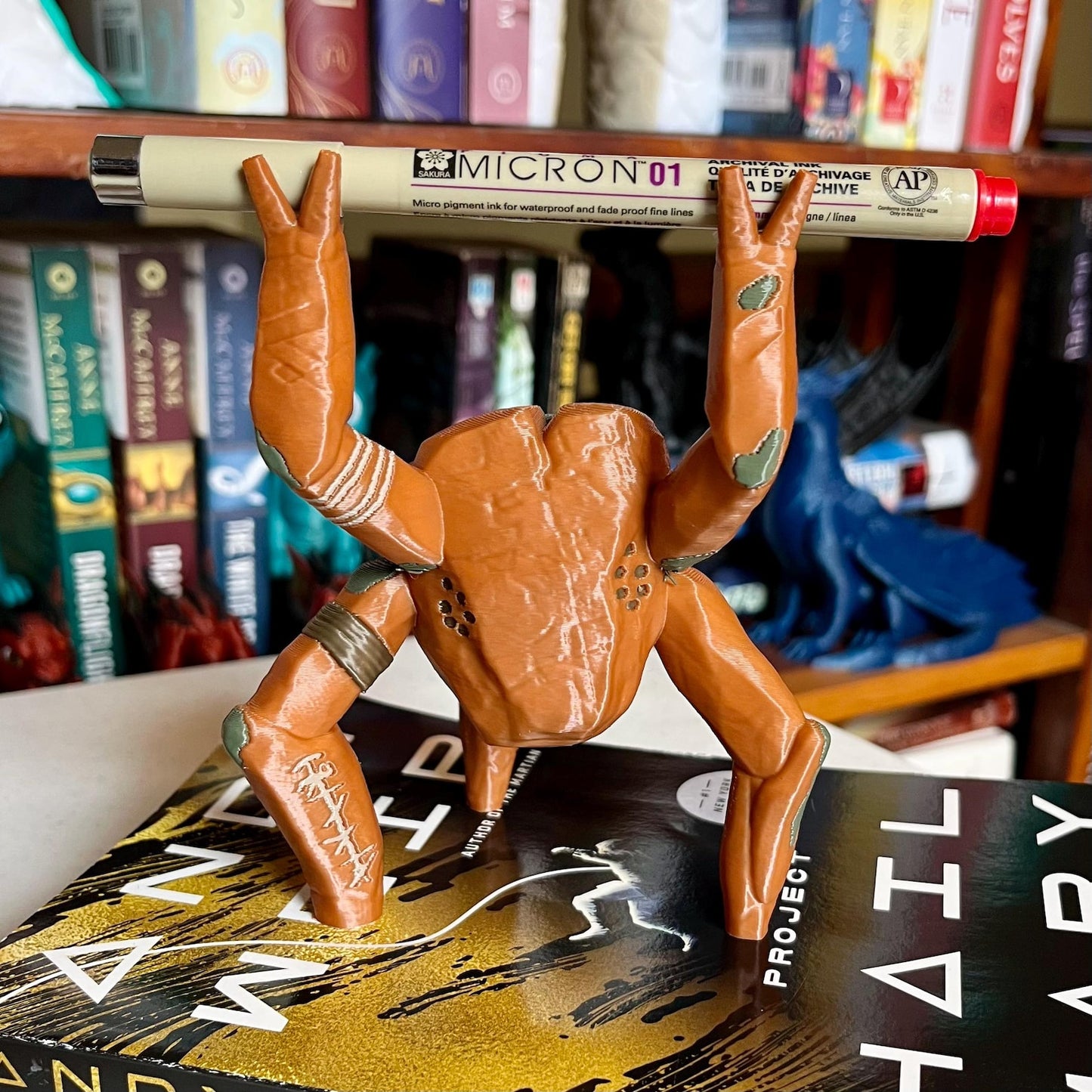 3D printed Rocky the Alien pen holder figure on a desk