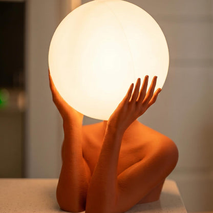 Sculptural sphere table lamp with modern ambient lighting for minimalist bedside decor