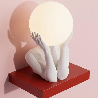 Sculptural sphere table lamp with modern ambient lighting for minimalist bedside decor